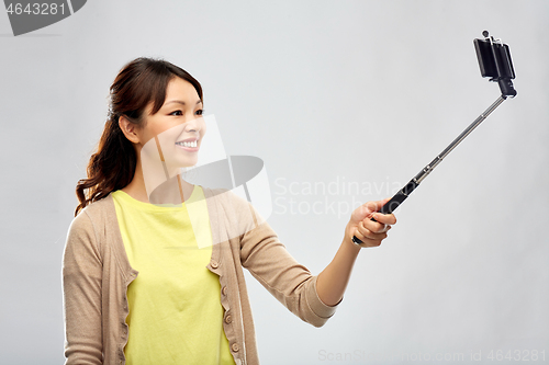 Image of asian woman taking selfie by smartphone