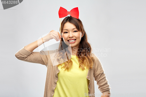 Image of happy asian woman with big red bow