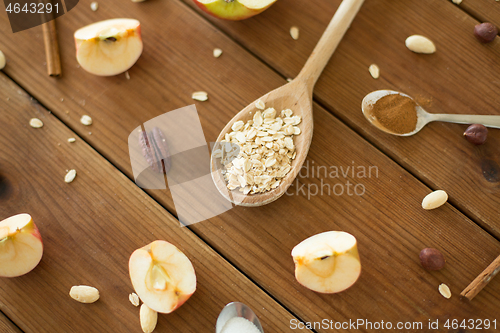 Image of apples, oatmeal, cinnamon, nuts and sugar