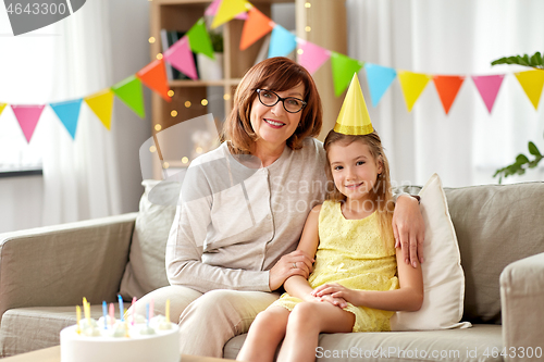 Image of grandmother and granddaughter with birthday cake
