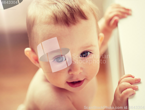 Image of happy little baby boy or girl at home