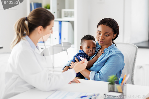 Image of mother with sick baby son and doctor at clinic