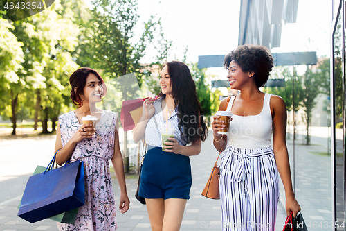 Image of women with shopping bags and drinks in city