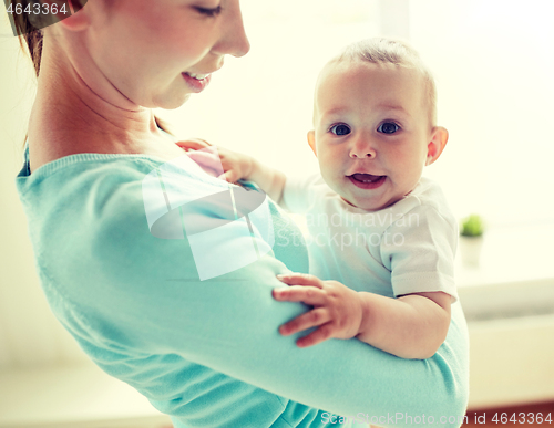 Image of happy young mother with little baby at home