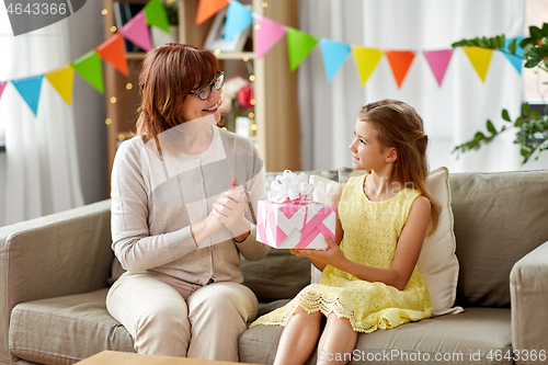 Image of grandmother giving granddaughter birthday gift