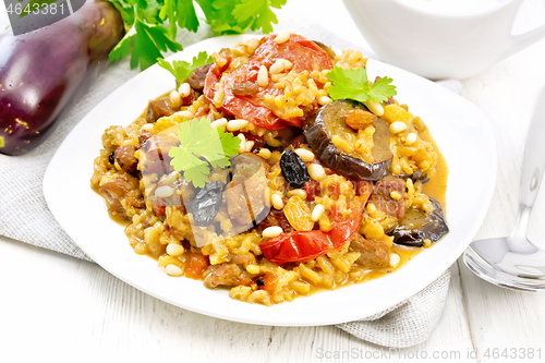 Image of Rice with vegetables and chicken in plate on wooden board