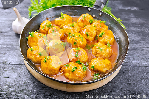 Image of Meatballs in pan on board