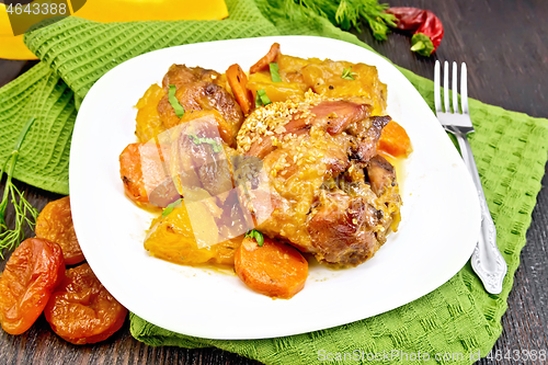 Image of Chicken roast with pumpkin and dried apricots on green napkin