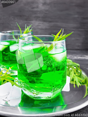 Image of Lemonade Tarragon with ice in two glasses on dark board