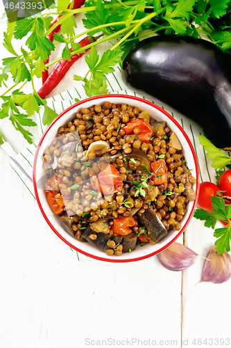 Image of Lentils with eggplant in bowl on light board top