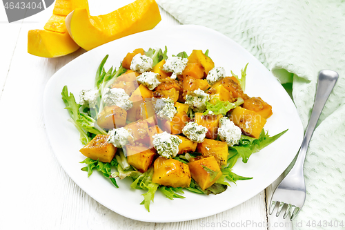 Image of Salad of pumpkin and cheese in plate on white board