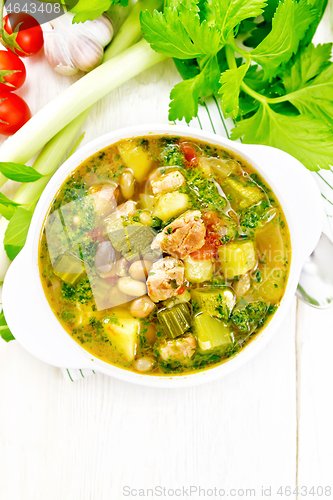 Image of Soup with pisto sauce in bowl on light board top