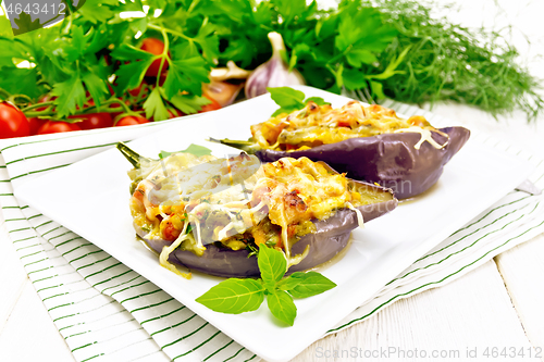 Image of Eggplant stuffed brisket and vegetables in plate on light board