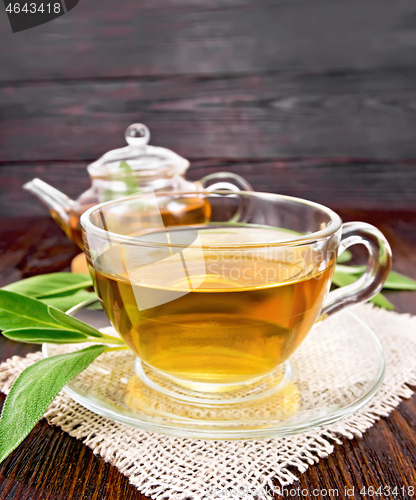 Image of Tea herbal with sage in glass cup on board