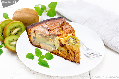 Image of Pie with kiwi in plate on wooden light board