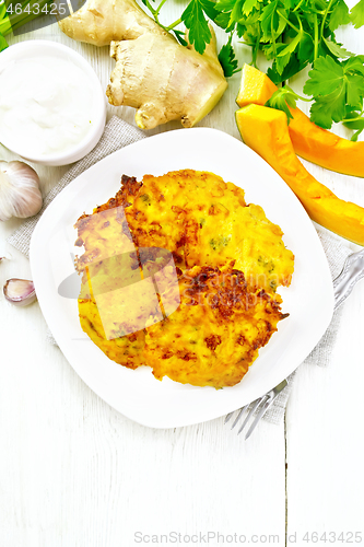 Image of Pancakes of pumpkin in plate on board top