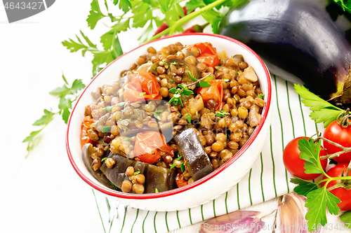 Image of Lentils with eggplant in bowl on board