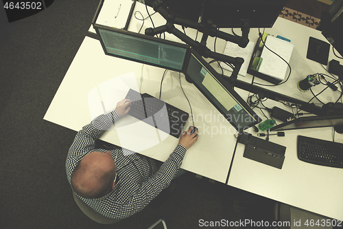 Image of young programmer writing programming code top view