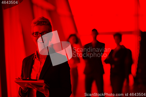 Image of business woman  at office with tablet  in front  as team leader