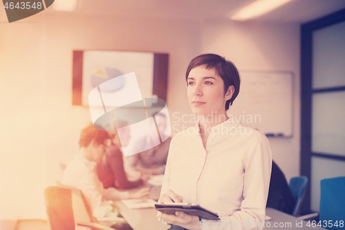 Image of business woman on meeting  using tablet computer