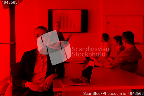 Image of portrait of young business woman at office with team on meeting 