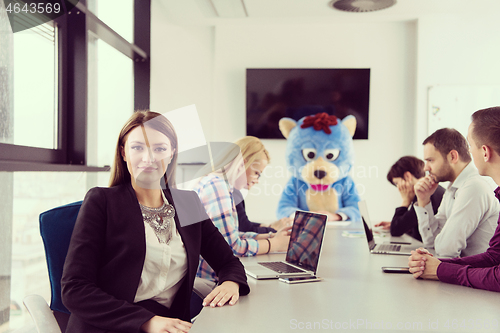 Image of boss dresed as bear having fun with business people in trendy of