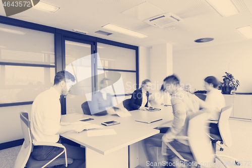 Image of business people group entering meeting room  motion blur