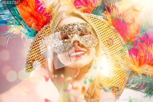 Image of Beautiful young woman in carnival mask