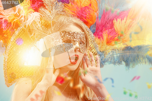 Image of Beautiful young woman in carnival mask