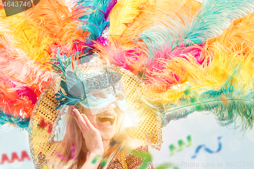 Image of Beautiful young woman in carnival mask