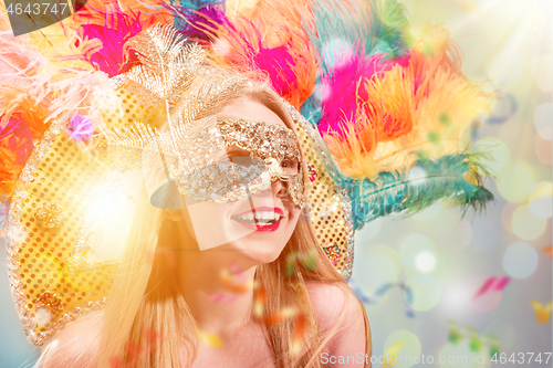 Image of Beautiful young woman in carnival mask