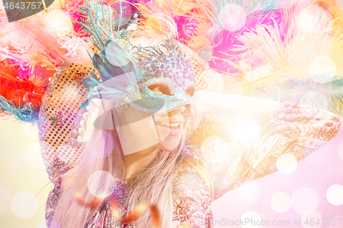 Image of Beautiful young woman in carnival mask