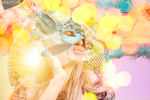 Image of Beautiful young woman in carnival mask