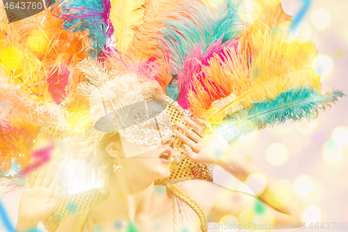 Image of Beautiful young woman in carnival mask