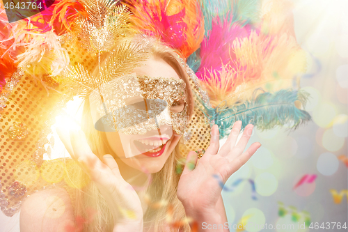 Image of Beautiful young woman in carnival mask