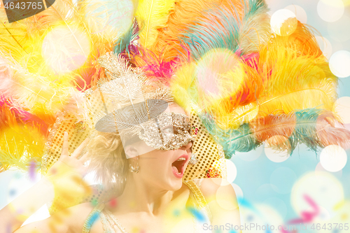 Image of Beautiful young woman in carnival mask