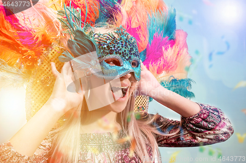 Image of Beautiful young woman in carnival mask