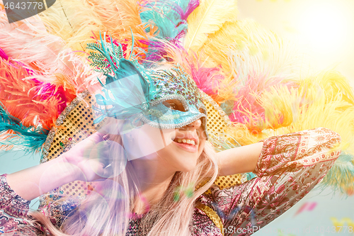 Image of Beautiful young woman in carnival mask