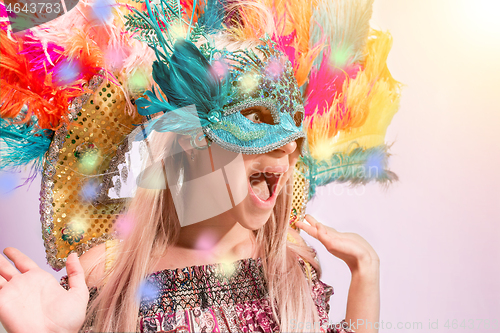 Image of Beautiful young woman in carnival mask