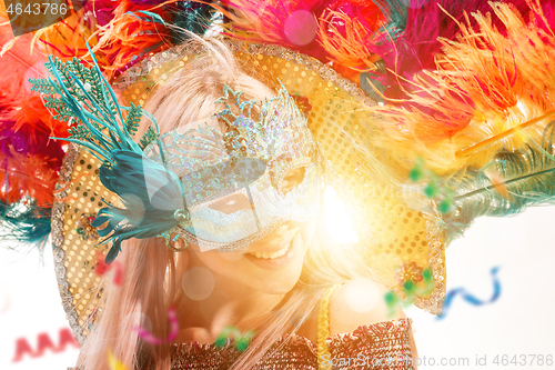 Image of Beautiful young woman in carnival mask