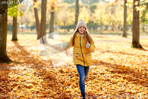 Image of happy girl running in autumn park