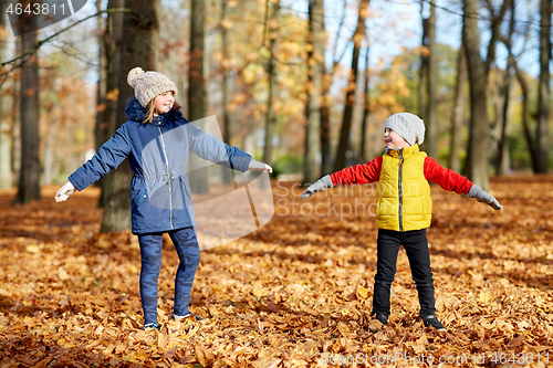 Image of happy children having fun at autumn park