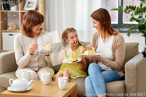 Image of mother, daughter and grandmother eating cake