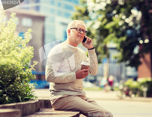 Image of happy senior man calling on smartphone in city