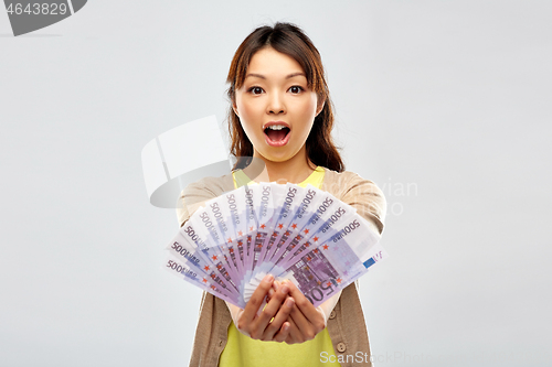 Image of asian woman with hundreds of euro money