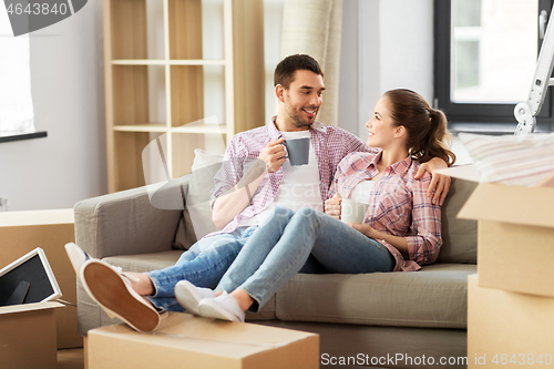 Image of happy couple drinking coffee moving to new home