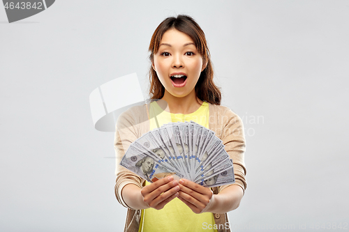 Image of asian woman with hundreds of dollar money