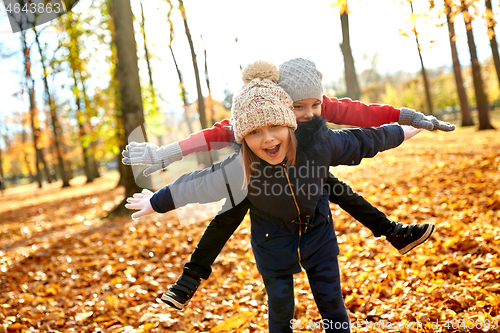 Image of happy children having fun at autumn park