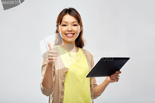 Image of happy asian woman using tablet computer