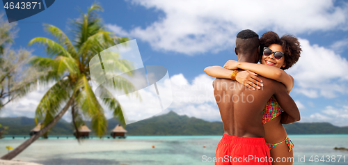 Image of african american couple hugging on summer beach